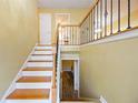 Inviting entryway with hardwood stairs, decorative railing, and views to the lower level at 2101 Newgate Dr, Decatur, GA 30035