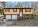 Charming split-level home with brick and siding, featuring a two-car garage and cozy front porch at 2101 Newgate Dr, Decatur, GA 30035