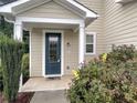 Inviting entryway with a decorative front door, well-kept landscaping, and a welcoming porch at 265 Edinburgh Ln, Woodstock, GA 30188
