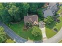 Aerial view of a beautifully landscaped home nestled on a large lot with mature trees and a curved driveway at 403 Glenhurst Trce, Canton, GA 30115