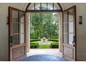 Ornate double doors opening to manicured garden with central fountain at 4975 Rebel Trl, Atlanta, GA 30327