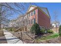 Brick townhome showing side view, including well-kept lawn and pedestrian walkway at 775 Mountain View Nw Ter, Marietta, GA 30064