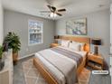 A bedroom featuring a ceiling fan, window and neutral colored bedding at 12981 Dartmore Cir, Alpharetta, GA 30005