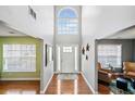 Inviting foyer with hardwood floors, high ceilings, large window, and a white front door at 4046 Arnolds Mill Opas, Douglasville, GA 30135