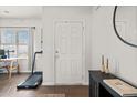 Clean entryway featuring a white door, adjacent to hardwood floors, with a console table at 828 Royal Red Ct, Mcdonough, GA 30253