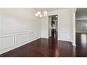 Elegant dining room featuring classic wainscoting, hardwood floors, and chandelier at 903 Hollytree Pl, Acworth, GA 30102