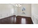 Charming dining area with dark hardwood floors, wainscoting, and a view to the outdoors at 903 Hollytree Pl, Acworth, GA 30102