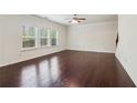 Spacious living room with hardwood floors, a ceiling fan, and ample natural light at 903 Hollytree Pl, Acworth, GA 30102