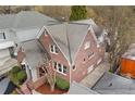 Aerial view of a well-maintained brick house with mature trees and a neat roof at 1181 Lanier Ne Blvd, Atlanta, GA 30306