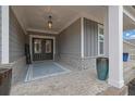 Inviting front porch featuring a patterned rug, stylish planters, and a view of the front door at 430 Parkbrook Way, Canton, GA 30114