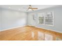 Living room featuring hardwood flooring and natural light, with a door leading to the exterior at 1002 Defoors Nw Lndg, Atlanta, GA 30318