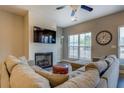 Cozy living room with fireplace, large windows, and comfortable sectional seating at 1840 Eastmore Ave, Conyers, GA 30094