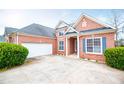 A stunning brick home features an attached garage and a well-kept yard at 2657 Neighborhood S Walk, Villa Rica, GA 30180