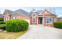 Beautiful brick home with manicured bushes, a garage, and a long driveway at 2657 Neighborhood S Walk, Villa Rica, GA 30180