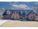Inviting brick home showcasing a beautifully maintained lawn and mature landscaping at 880 Streamside Dr, Mcdonough, GA 30252