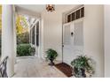 Inviting front entrance with double doors, complemented by potted plants and stone tile flooring at 2 W Muscogee Nw Ave, Atlanta, GA 30305