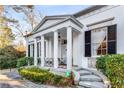 Close-up of the columned front porch, showcasing detailed iron railings and manicured landscaping at 2 W Muscogee Nw Ave, Atlanta, GA 30305