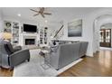Inviting living room with a fireplace, built-in shelves, hardwood floors, and an open floor plan at 4084 Peachtree Dunwoody Ne Rd, Atlanta, GA 30342