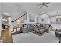 Spacious living area featuring hardwood floors, a staircase, and views into the kitchen at 4084 Peachtree Dunwoody Ne Rd, Atlanta, GA 30342