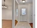 Inviting foyer with a view of the front door, dining area, and stylish light fixture at 500 Allen'S Landing Ct, Lawrenceville, GA 30045