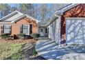 A close-up view of the front exterior, highlighting the walkway, door, and attached garage at 500 Allen'S Landing Ct, Lawrenceville, GA 30045