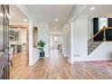 Bright, open foyer with wood floors, recessed lighting, and view to kitchen and staircase at 6641 Poplar Grove Way, Stone Mountain, GA 30087