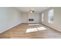 Bright and airy living room featuring luxury vinyl plank flooring and a modern electric fireplace at 129 Belvedere Rd, Mcdonough, GA 30253