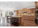 Spacious kitchen with granite countertops, stainless steel appliances, and center island with seating at 771 Park Manor Se Dr, Smyrna, GA 30082