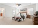 Serene primary bedroom with neutral colors, bench seat, and large windows at 771 Park Manor Se Dr, Smyrna, GA 30082