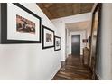 Hallway featuring dark wood floors and framed art, leading to a door at 855 Peachtree St # 2901, Atlanta, GA 30308
