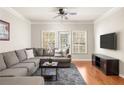 Cozy living room with hardwood floors, large windows, and a comfy sectional sofa at 1225 Westchester Ne Rdg, Atlanta, GA 30329