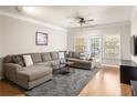 Stylish living room features a large sectional, hardwood floors, and modern TV console at 1225 Westchester Ne Rdg, Atlanta, GA 30329