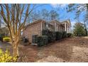 Side view of brick house shows access and lush landscaping with a gentle slope at 405 Putting Green Ln, Roswell, GA 30076