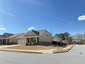 A well-maintained corner lot home with professional landscaping and attached garage at 1649 Auburn Ridge Way, Dacula, GA 30019