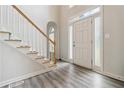 Bright foyer features new floors, a staircase with wooden handrail, and a modern front door at 3605 Summit Gate Dr, Suwanee, GA 30024