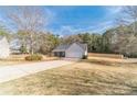 Charming single-story home featuring stone accents, neutral siding, a two-car garage, and a well-manicured lawn at 704 Stonecrest Ln, Loganville, GA 30052