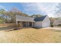 Charming single-story home featuring stone accents, neutral siding, a two-car garage, and a well-manicured lawn at 704 Stonecrest Ln, Loganville, GA 30052