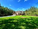 Beautifully landscaped front yard showcasing the home's exterior with an attached garage at 136 Rainey Rd, Temple, GA 30179