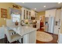 Bright kitchen featuring white cabinets, granite countertops, and stainless steel appliances at 2000 Stethem Ferry Rd, Johns Creek, GA 30022