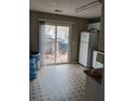 Kitchen area with stainless steel refrigerator and sliding door to outdoor porch at 2760 Waterford Park Dr, Lawrenceville, GA 30044