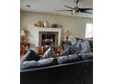 Cozy living room with a brick fireplace, comfortable sofa, and ceiling fan at 2760 Waterford Park Dr, Lawrenceville, GA 30044