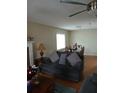 Cozy living room area with hardwood floors, comfortable seating, and a ceiling fan at 2760 Waterford Park Dr, Lawrenceville, GA 30044