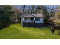 View of the front yard of the home, showing the lawn, trees, and exterior features at 2183 Rhinehill Se Rd, Atlanta, GA 30315