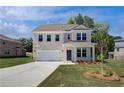 Two-story home features a manicured lawn, long driveway, and covered front porch at 237 Chiswick Loop, Stockbridge, GA 30281