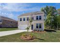 Two-story home with a two-car garage, charming front yard, and a long driveway at 237 Chiswick Loop, Stockbridge, GA 30281