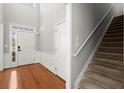 Bright entryway with hardwood floors and staircase at 3805 Delfaire Trce, Cumming, GA 30040