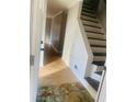 Hallway view features wood floors and staircase with dark stained treads at 5206 Westhill Nw Dr, Norcross, GA 30071