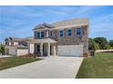 Attractive brick home with a two-car garage, featuring a well-kept lawn at 132 Dalston Cv, Stockbridge, GA 30281