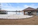 Lakeside home featuring a private beach, boat storage, and scenic views of the calm water at 3167 Bay View Dr, Jonesboro, GA 30236
