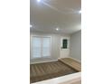 Bright living room featuring neutral paint, new carpet, and natural light streaming through the window at 3260 Valley Bend Rd, Atlanta, GA 30349